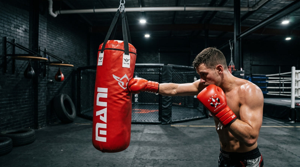 Boxer training on a heavy punching bag in a gym